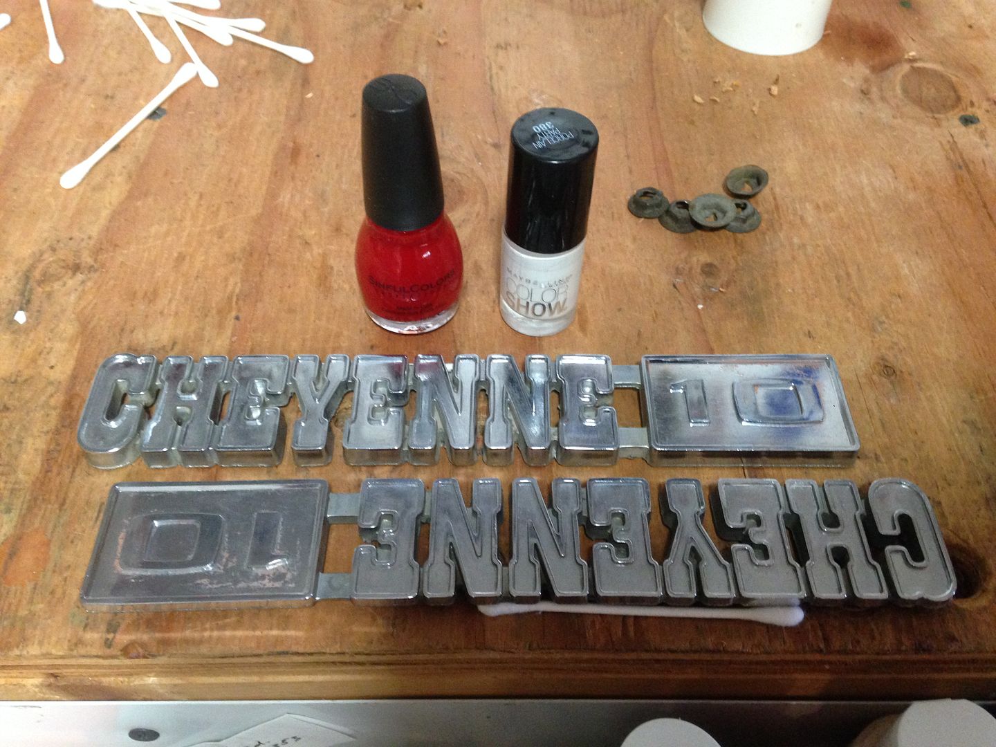 Painting emblems using lacquer paint and a hypodermic syringe The